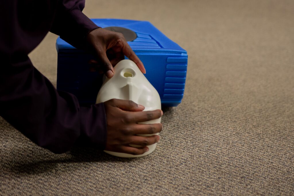 A closeup shot of a man practicing cardiopulmonary resuscitation (CPR)